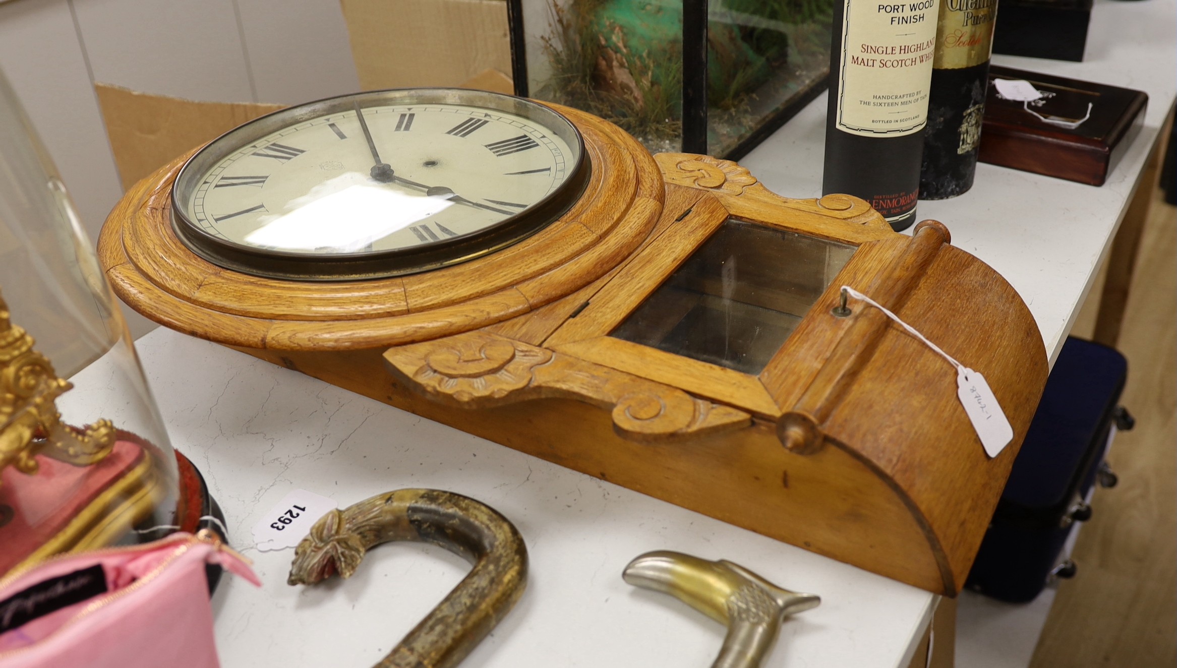 An oak cased drop dial wall clock, with key and pendulum